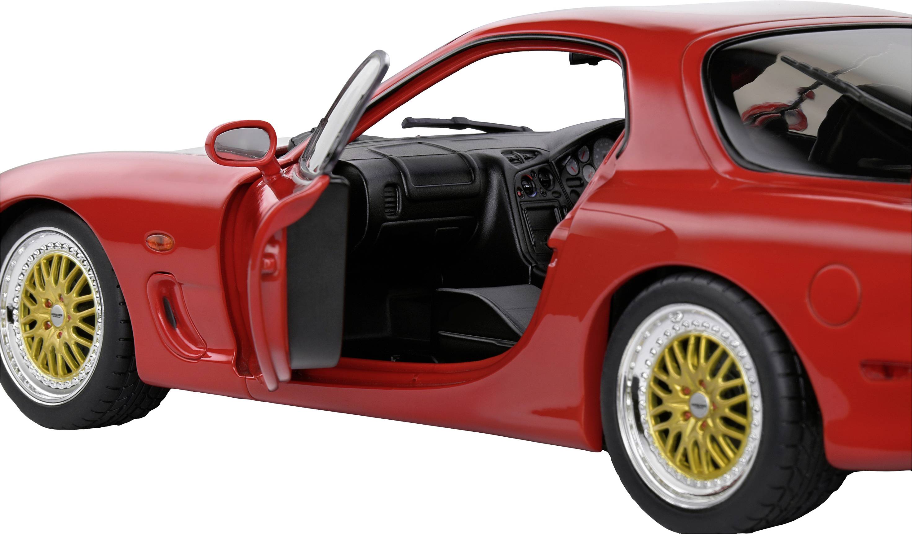 A red sports car with an open driver's door, gold alloy wheels, and a black interior. The focus is on the detailed design.
