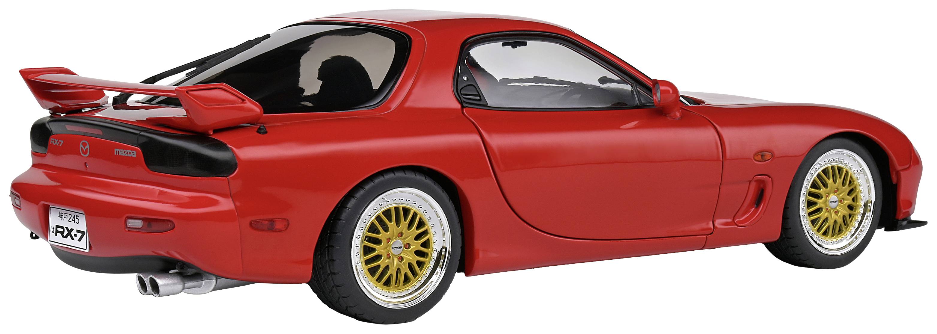 Red sports car with prominent rear spoiler, gold wheels, and lowered suspension, viewed from the side.
