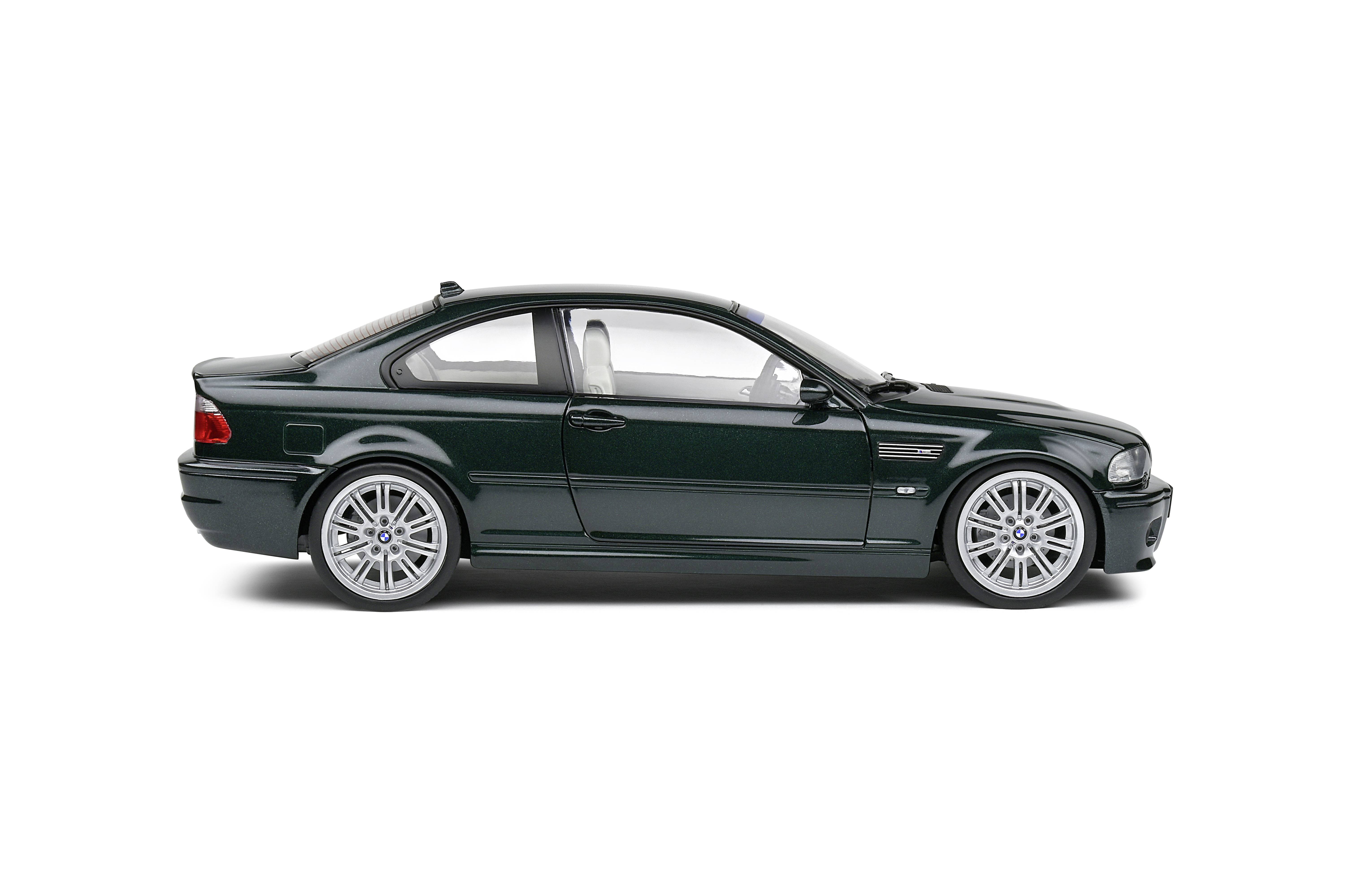 Dark green sports coupé, side view from the left, on a white background.