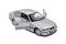 Silver model car with open doors, dark windows, and detailed tyres, positioned on a white surface.