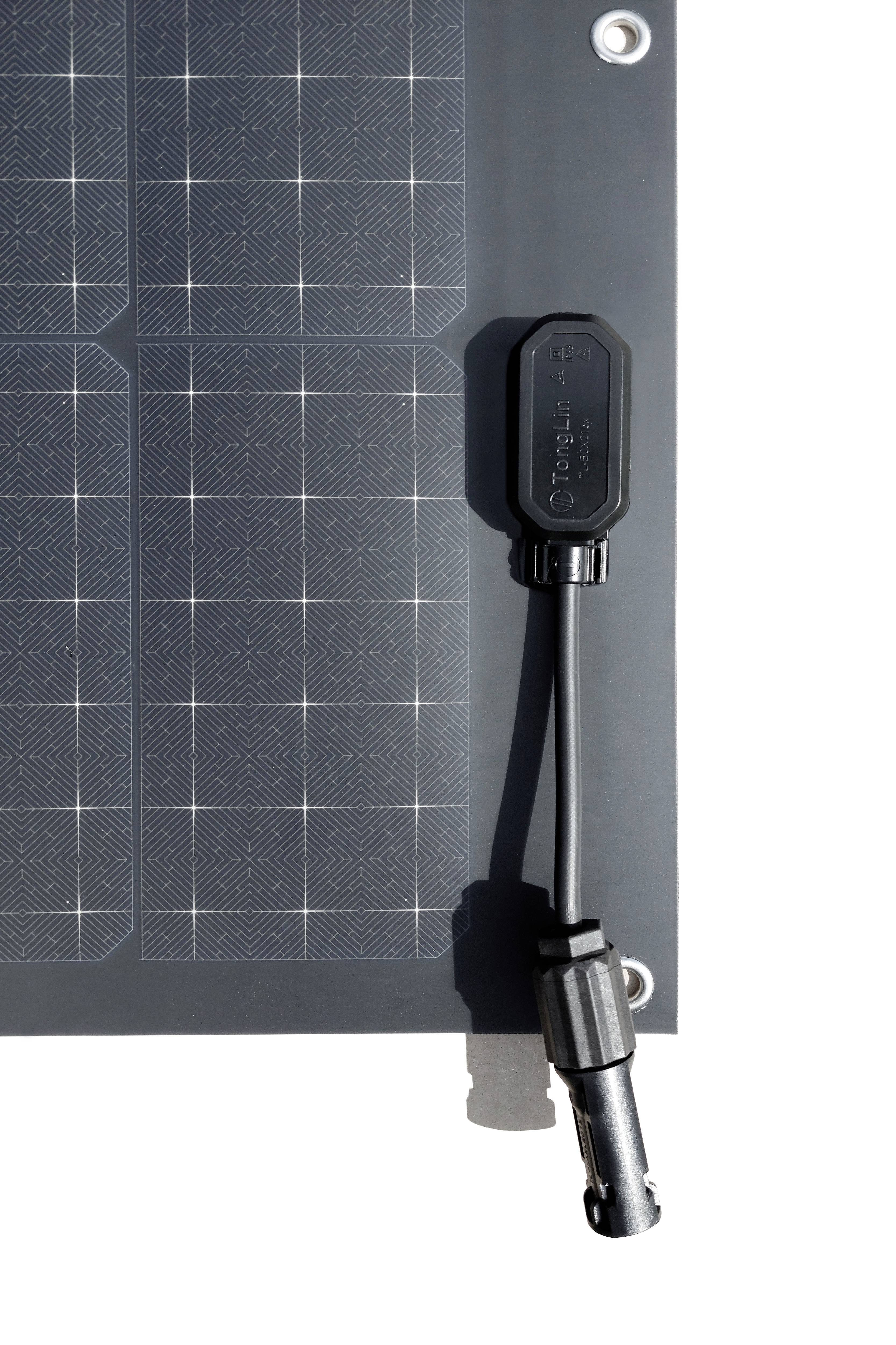 A solar module with a visible connector and connection cable for energy transmission.
