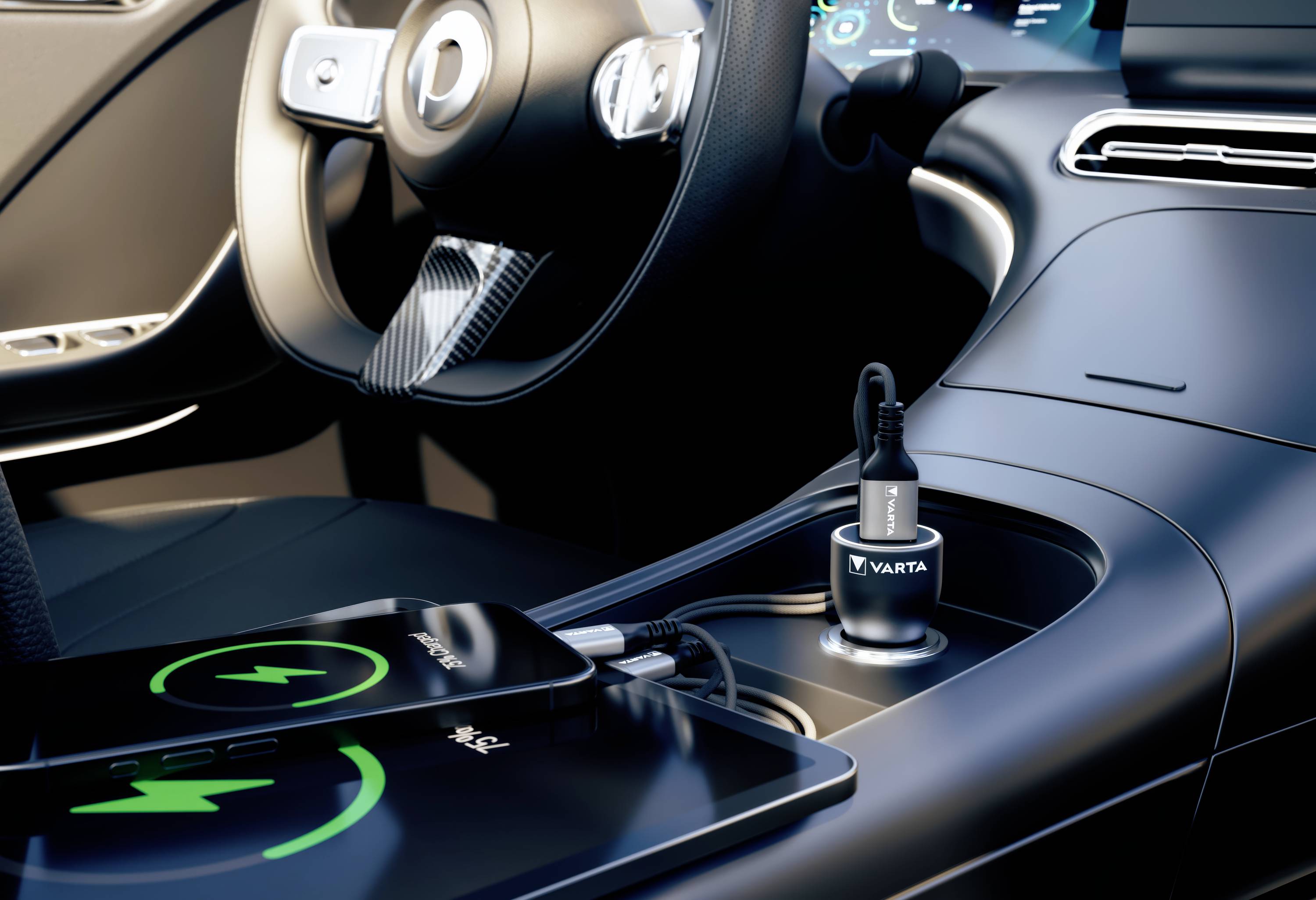 A mobile phone is being charged in a car via a VARTA adapter. The charger is plugged into the cigarette lighter.