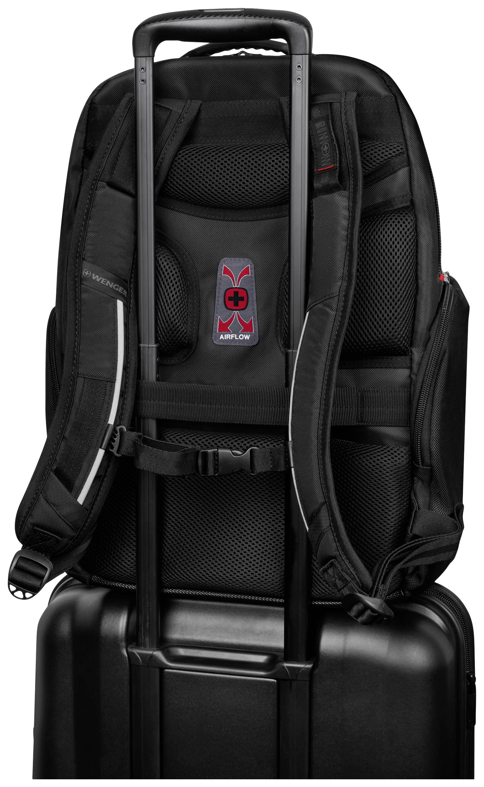 Black rucksack with padded straps and brand logo, attached to a wheeled suitcase, demonstrates practical transport option.