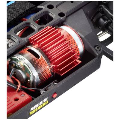 Close-up of a red electric motor with cooling fins in a technical device. A yellow switch with 'POWER ON/OFF PRESS AND HOLD'.