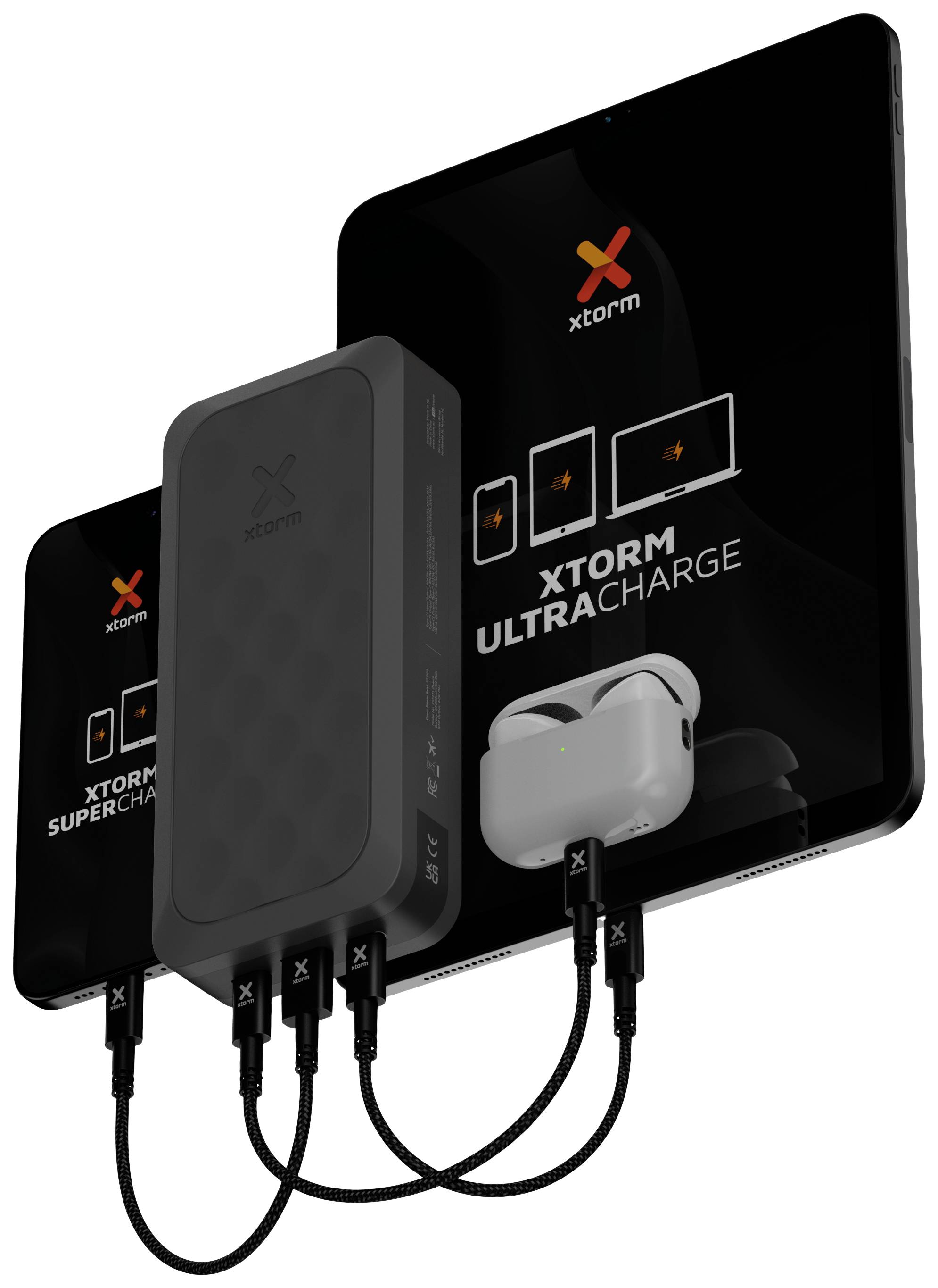 A black Xtorm charger is charging three devices: a smartphone, a tablet with the inscription 'XTORM ULTRACHARGE', and AirPods.