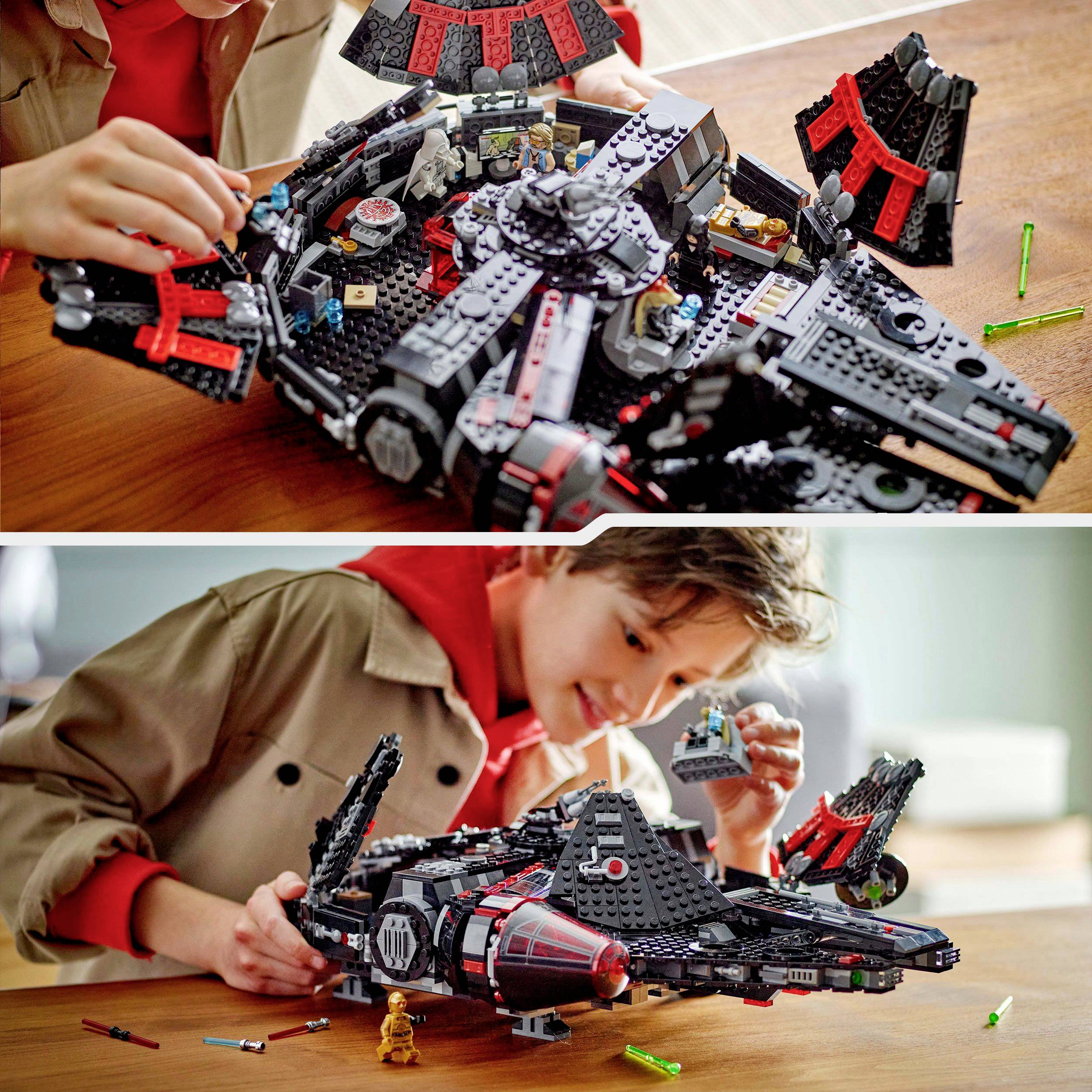 A child is playing with a detailed, assembled spaceship model. The spaceship has black and red elements.