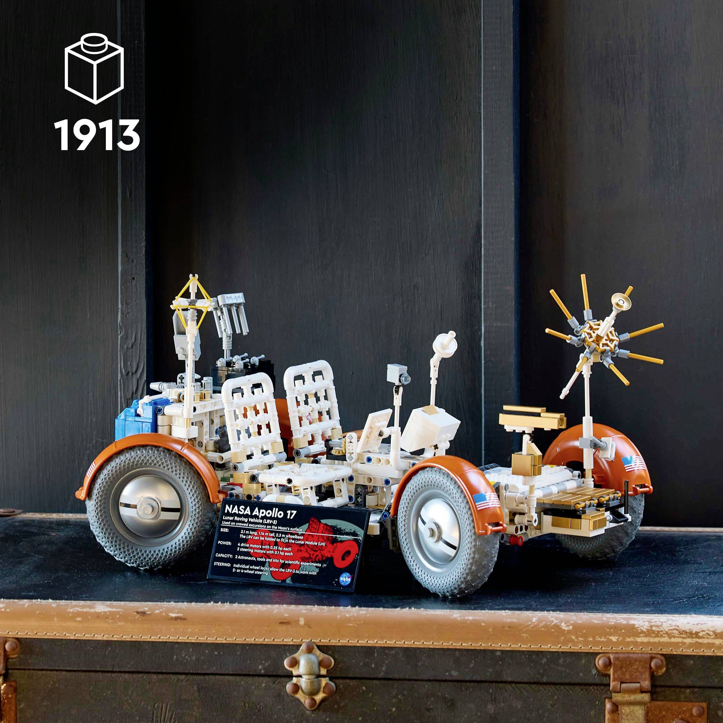 Lego model of the NASA Apollo lunar rover with detailed accessories, displayed on an old chest.