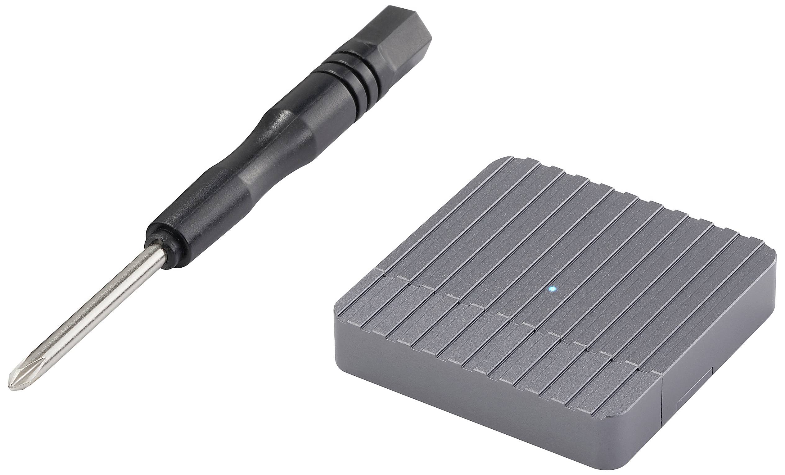 Small silver device with ridged surface next to a black screwdriver with metal tip, on white background.