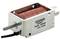 Cylindrical electromagnetic coil with red winding material, metal frame and label displaying manufacturer information and technical specifications.