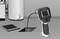 'Endoscope camera inspects hard-to-reach area through floor opening, next to a boiler.'