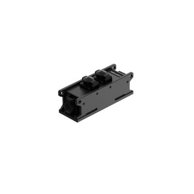 Black, rectangular mechanical component with two round plug connectors on top. Used in electrical or industrial applications.
