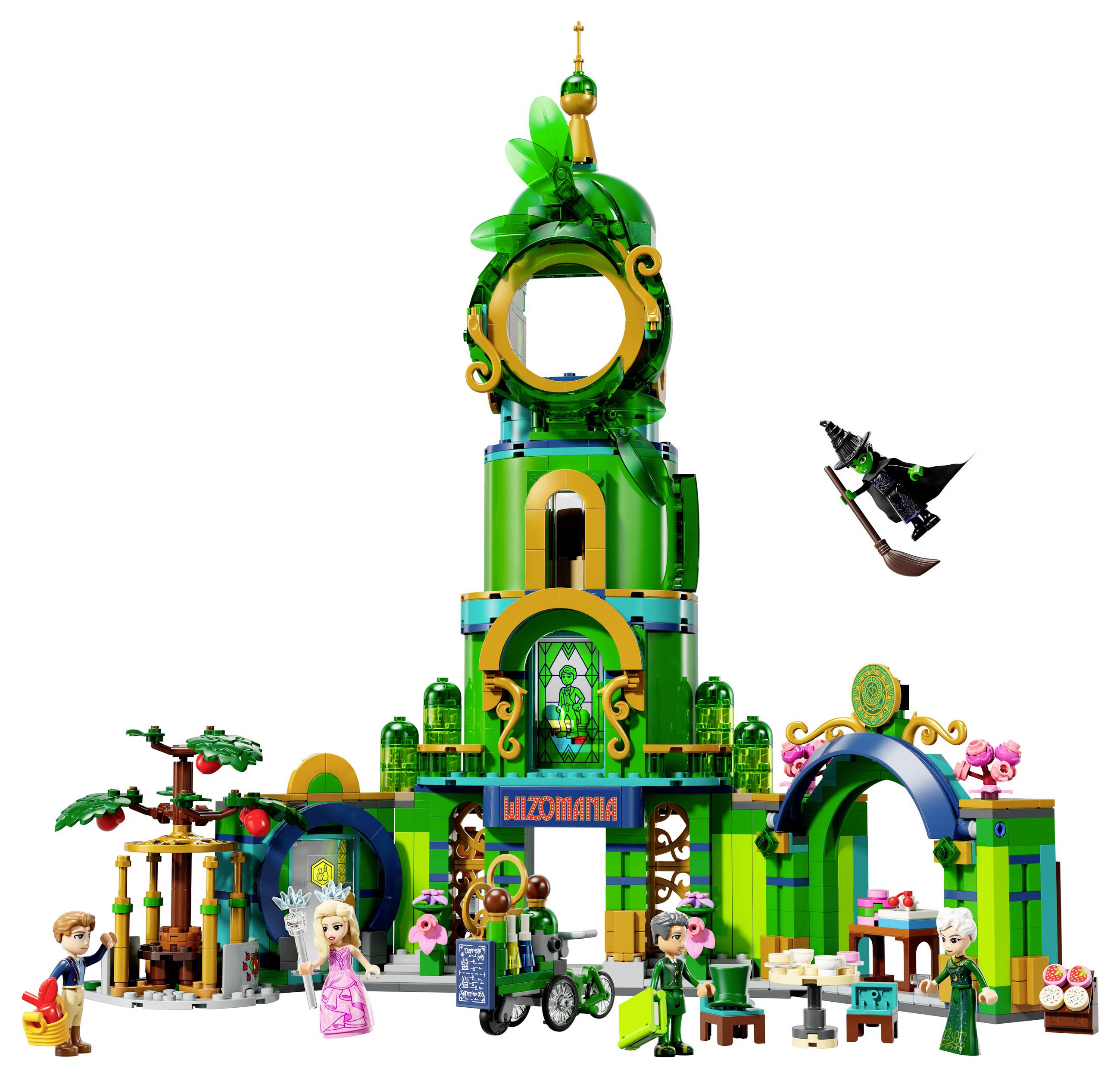 A Lego set displays a green tower structure with plant motifs. Figures, including a princess and a witch on a broomstick, are scattered around the tower.
