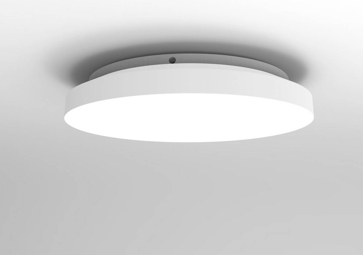 A round, modern, white ceiling light hanging from above and shining brightly.