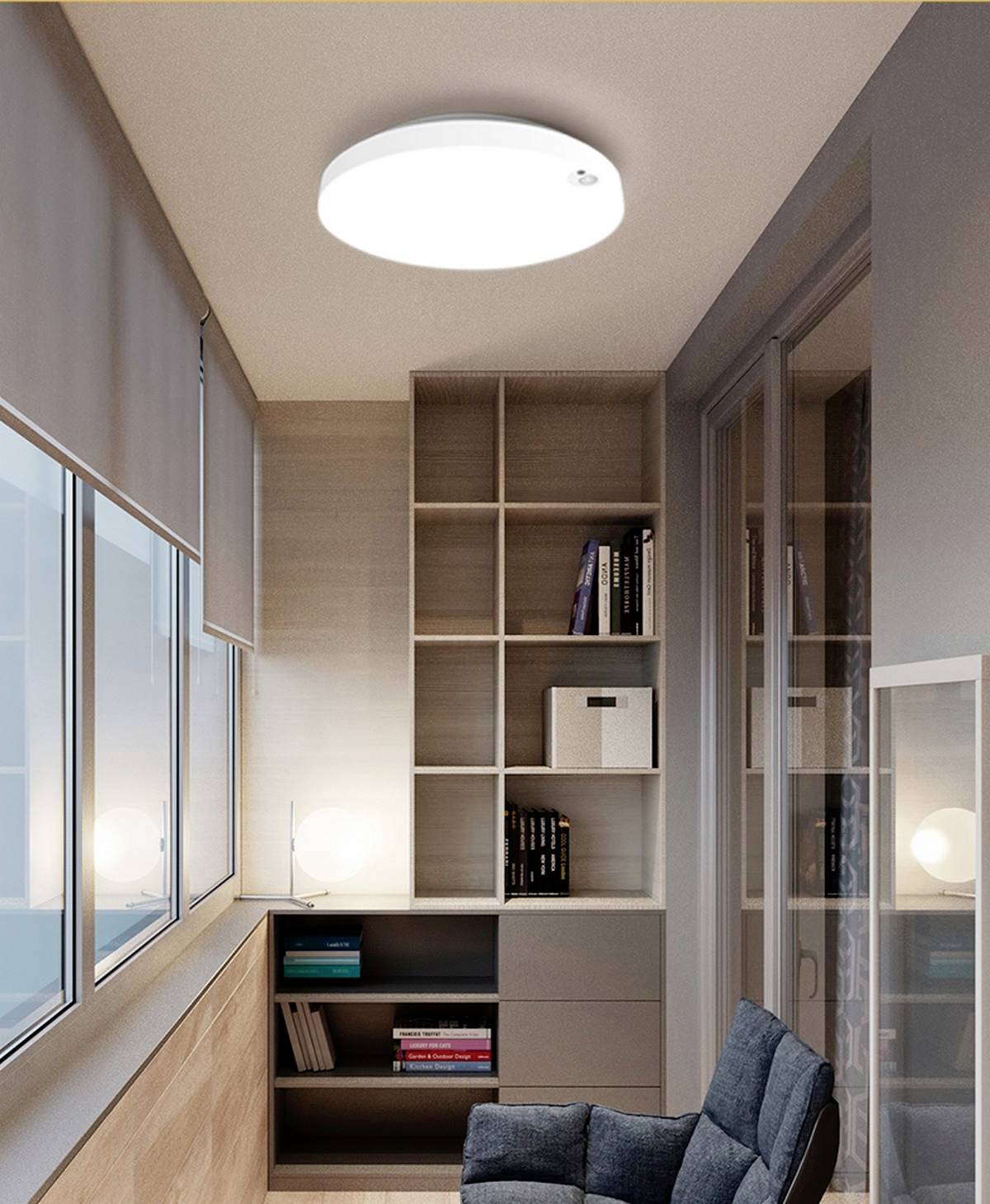 A small workspace with a wall-mounted bookshelf filled with books, a comfortable chair, and a bright ceiling light.