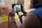 A person is scanning the barcodes on packages in a warehouse using a handheld device. The packages are marked with yellow labels.