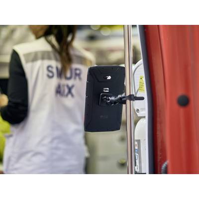 A person wearing a SMUR AIX jacket is standing in an ambulance. A tablet is mounted on a holder within the vehicle.