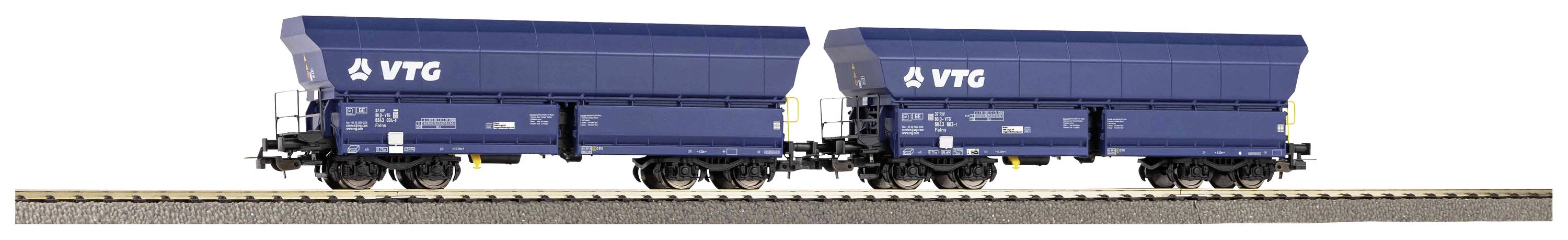 Two blue freight wagons on a track, each with the inscription 'VTG'. The wagons are identical and positioned in a row.