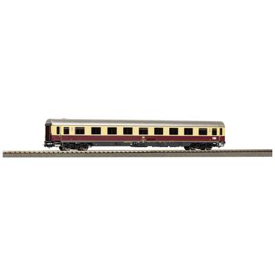 A model railway passenger carriage, painted burgundy and beige, stands on a track. The carriage has multiple windows and detailed markings.