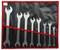 A set of spanners in various sizes, arranged from large to small, in a black and red tool holder.