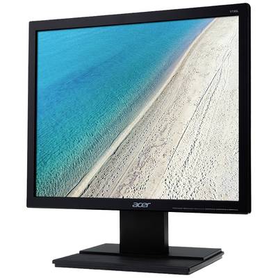 A monitor displays an image of a beach with bright sand and turquoise-blue sea.