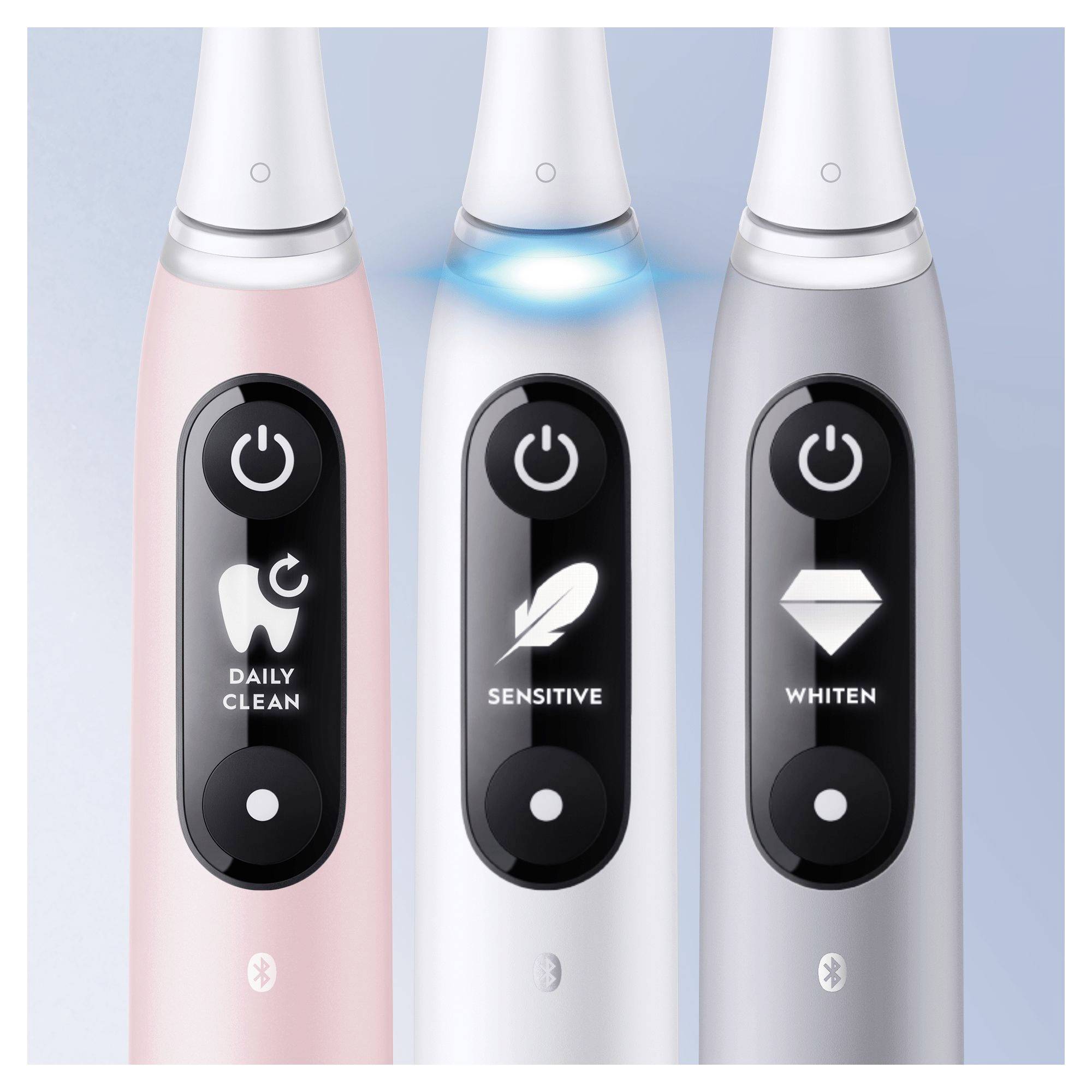 Three electric toothbrushes with different modes: 'Daily Clean', 'Sensitive' and 'Whiten'. The middle toothbrush is illuminated in blue.