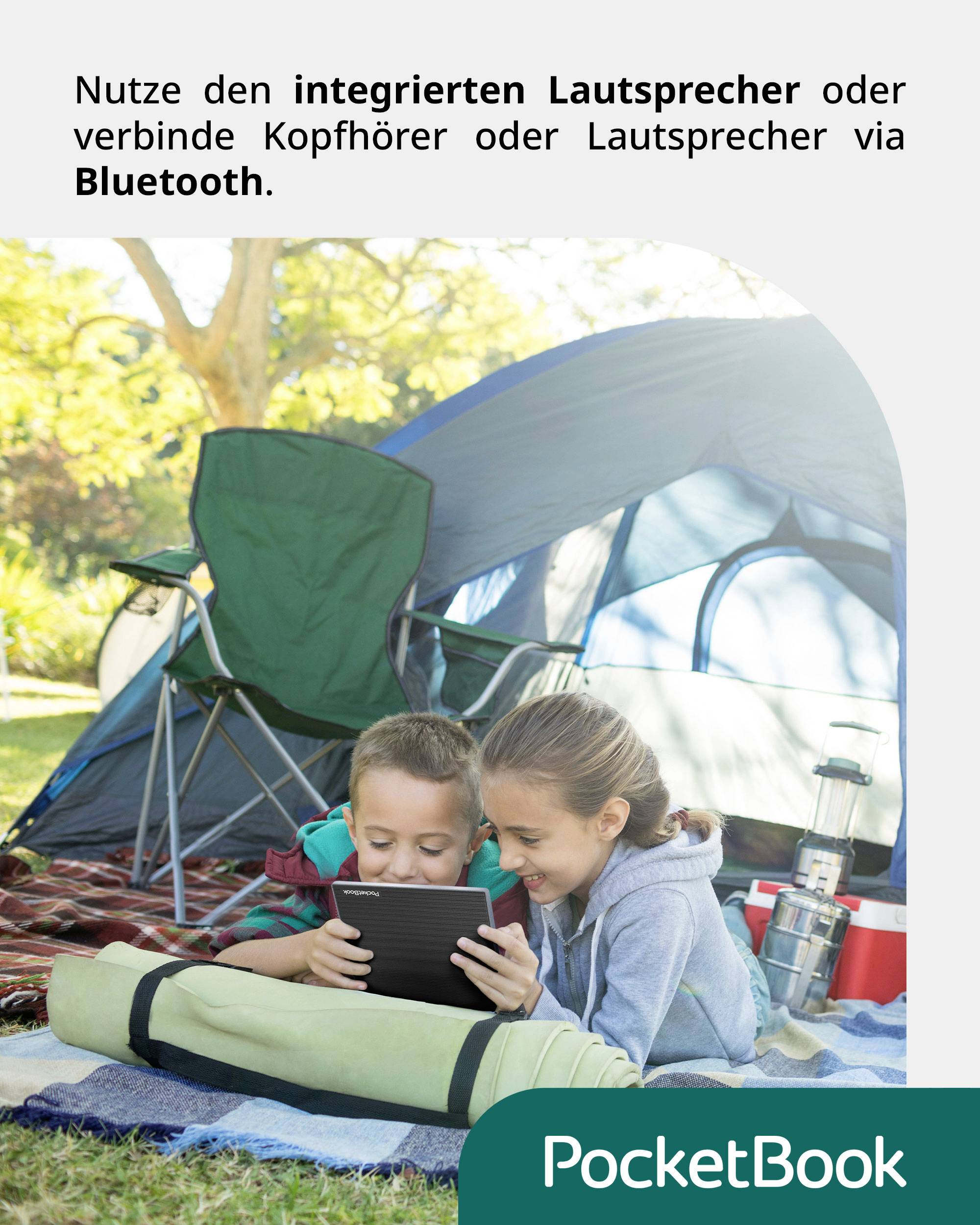 A woman and a boy are lying on a blanket outside in front of a tent, looking at a tablet. Text: 'Use the built-in speaker...'.