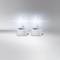 Two bright xenon lamps against a grey background. They are emitting intense, white light and positioned side by side.
