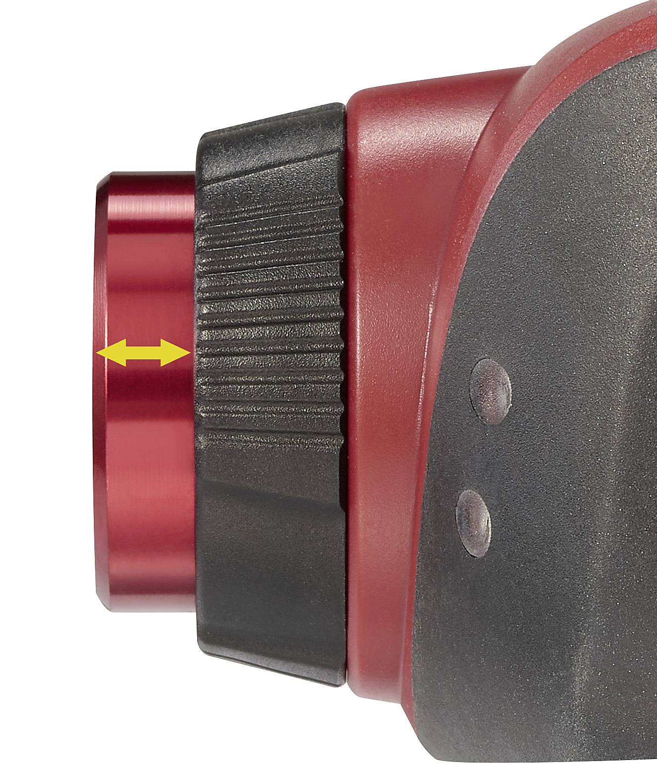 Close-up of a red mechanical component with a yellow double-arrow marker indicating an adjustment direction.