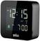 Black digital alarm clock displays '12:15 AM', with an activated alarm bell and '7:00 AM' set as the alarm time. Brand 'Braun'.