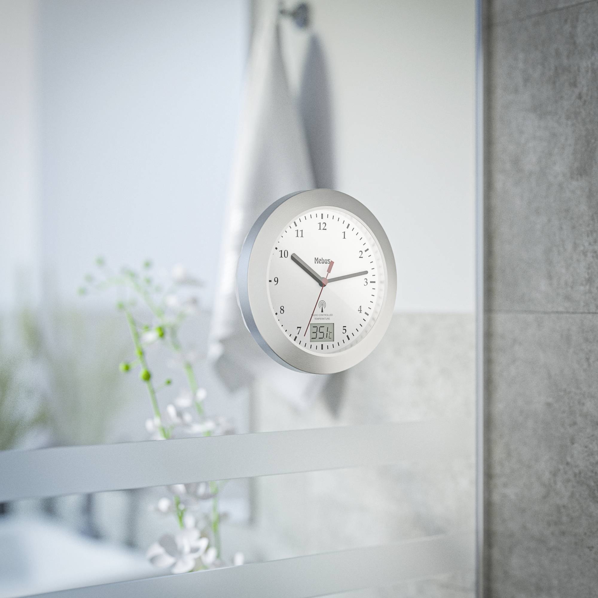 A silver wall clock shows 11:07. In the background, plant decorations and a towel are blurrily visible.