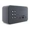 Black alarm clock with a rectangular display, five buttons on the left side for functions such as radio, alarm, and snooze.