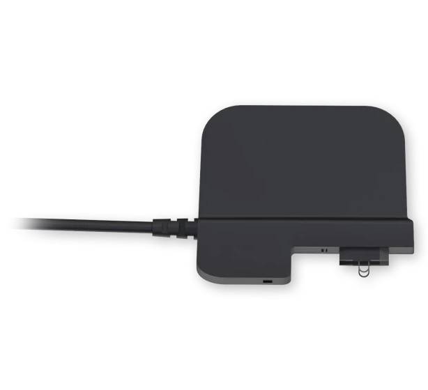 A black electronic device with a cable, likely a charger or docking station. Rectangular in shape with rounded edges.
