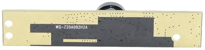 An electronic circuit board with a golden surface and black pattern, two holes at the ends and a camera lens in the centre.