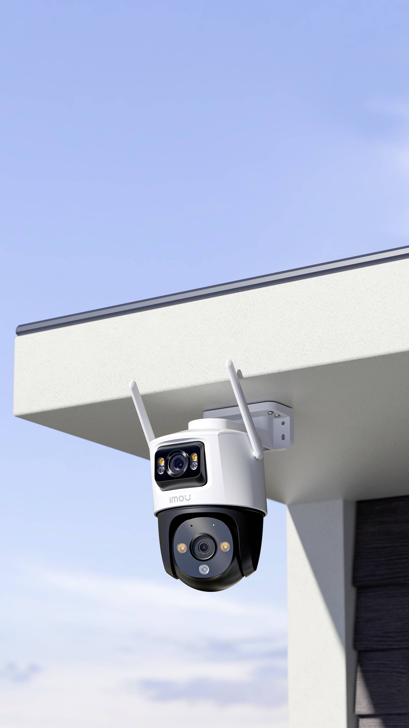 Security camera mounted on the corner of a building, pointing towards the sky.