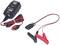 Battery charger with cables; on the left, a device with LED indicators, on the right red and black clamps. For charging batteries.
