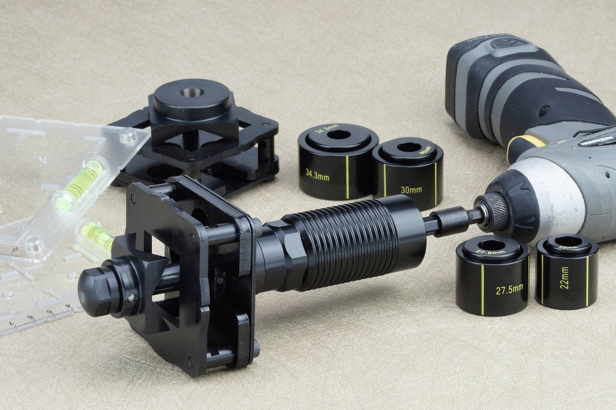 A set of cutting tools and a drill for installing taps. Includes various hole saws in different sizes.