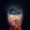 'A black, robust work shoe hovers above a luminous orange, smoking plinth that looks like lava.'