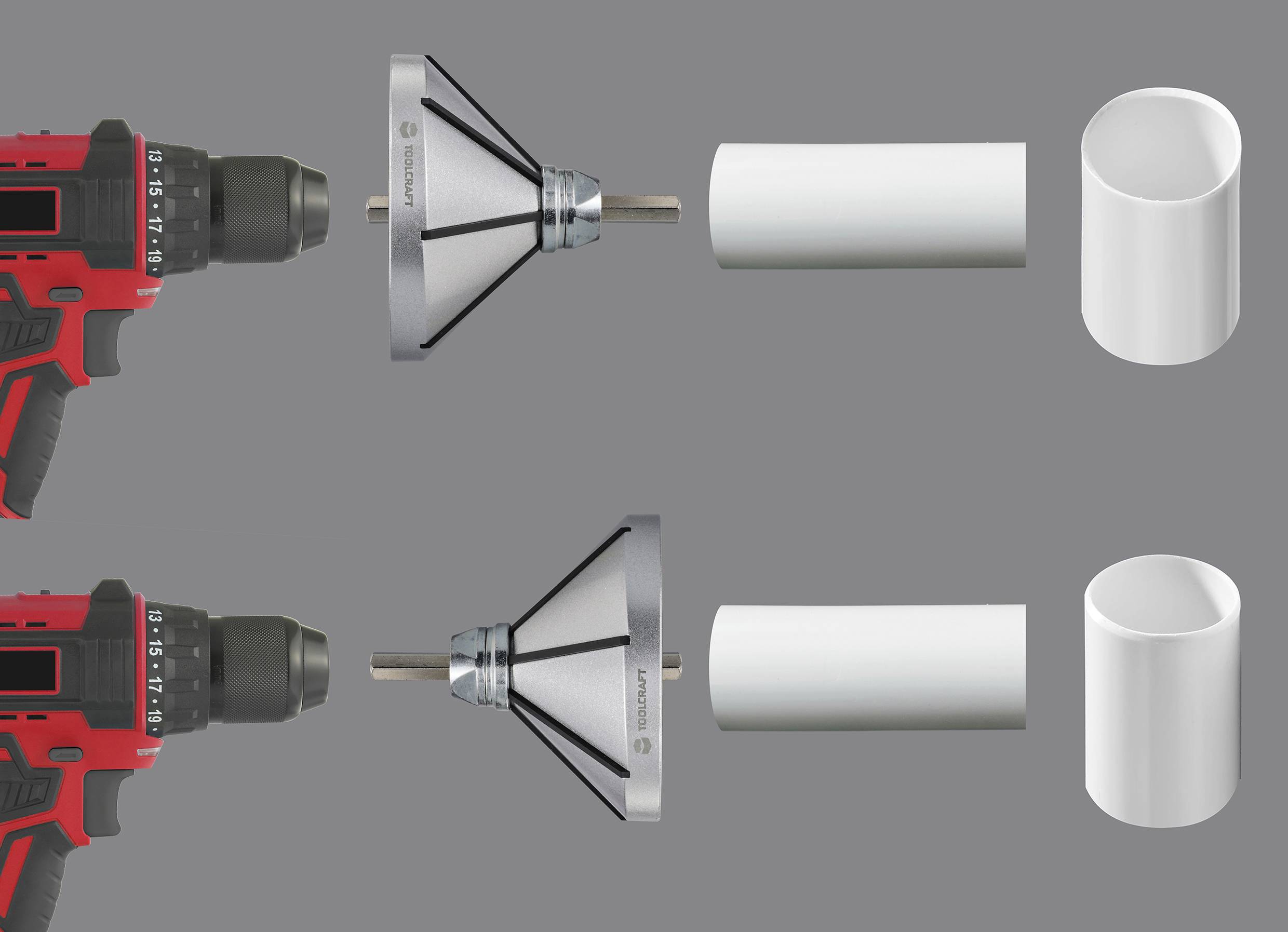 A red electric drill with a conical attachment is pointed at two white cylindrical objects against a grey background.