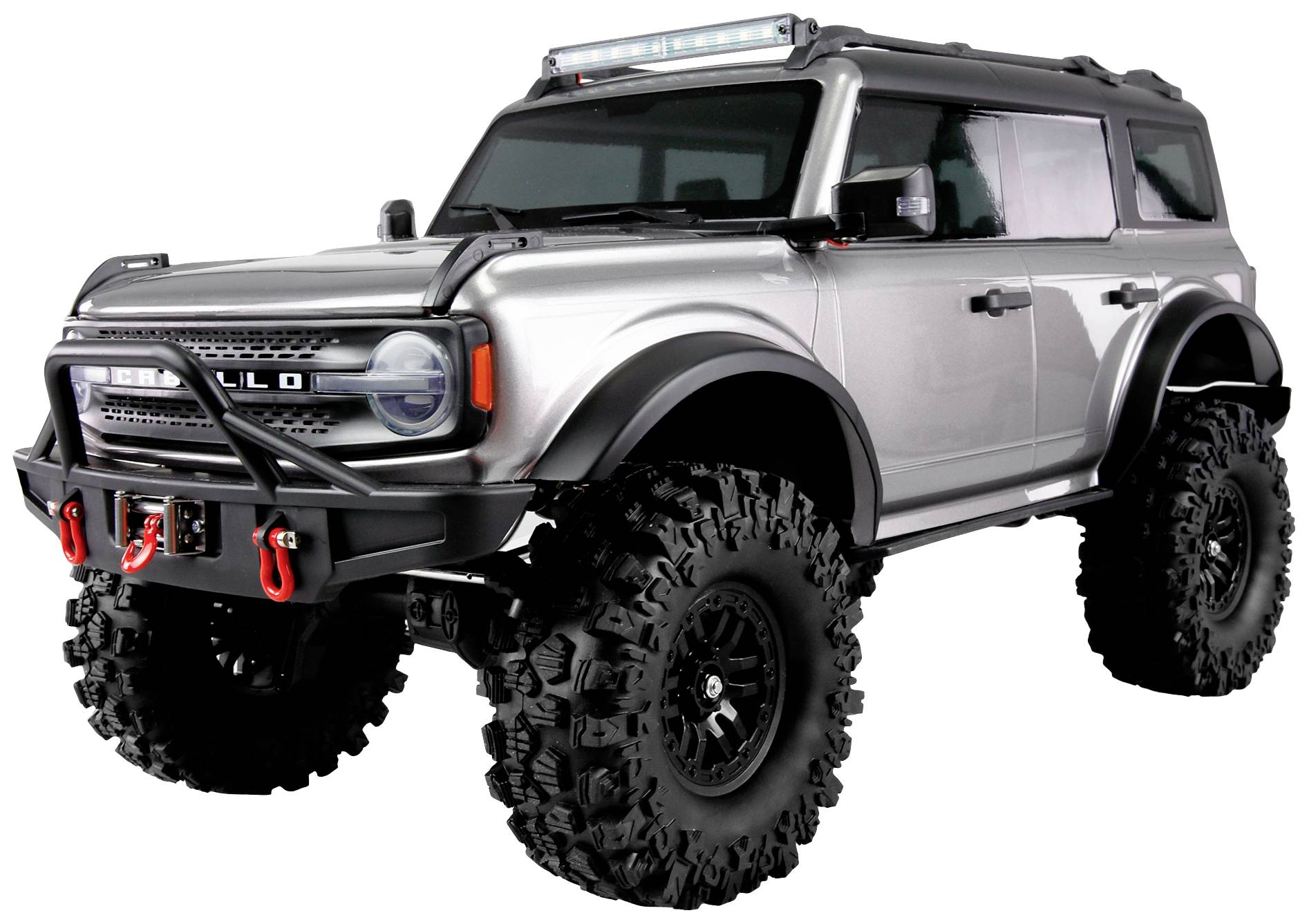 A silver off-road vehicle with high ground clearance and off-road tyres, viewed from the side.