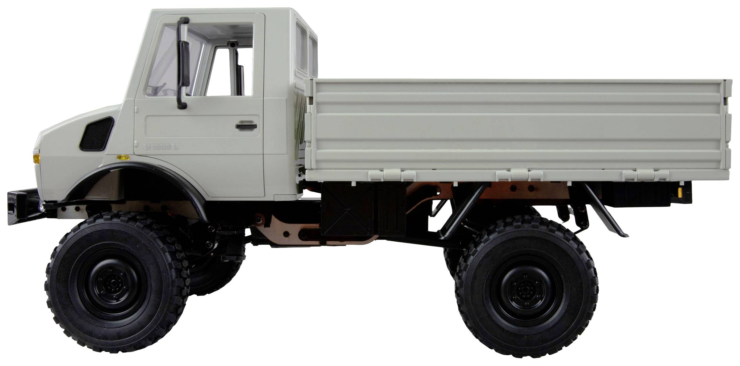 A white lorry with high ground clearance and robust tyres, pictured from the side. The cab is compact and enclosed.