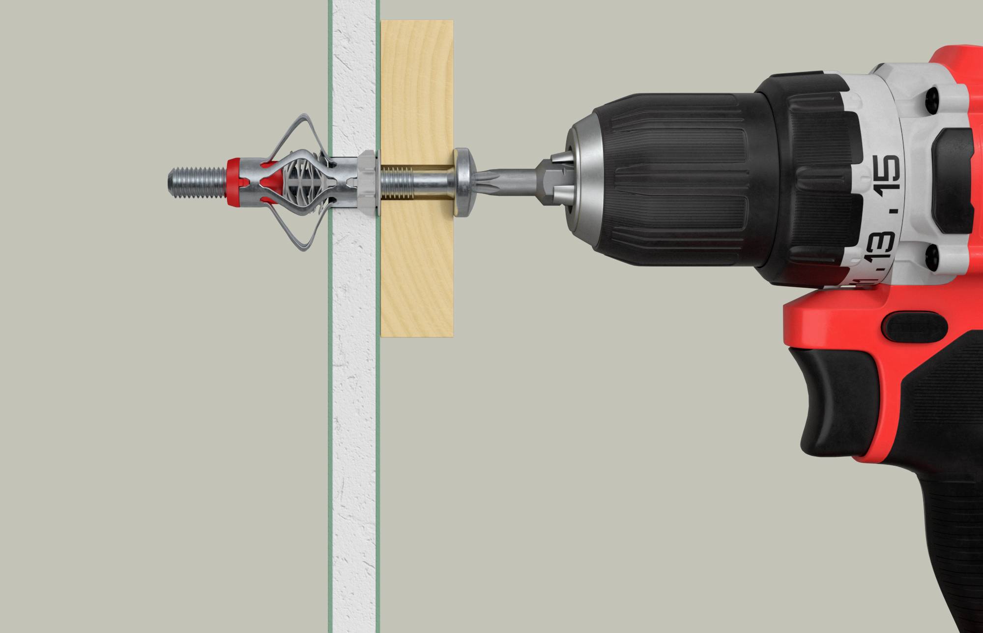 A drill is pulling a metal wall plug through a wall with a piece of wood as a spacer.