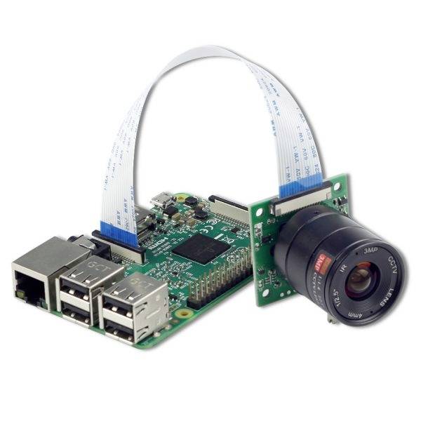 An electronic circuit with a circuit board featuring multiple USB ports. A camera is connected via a ribbon cable.