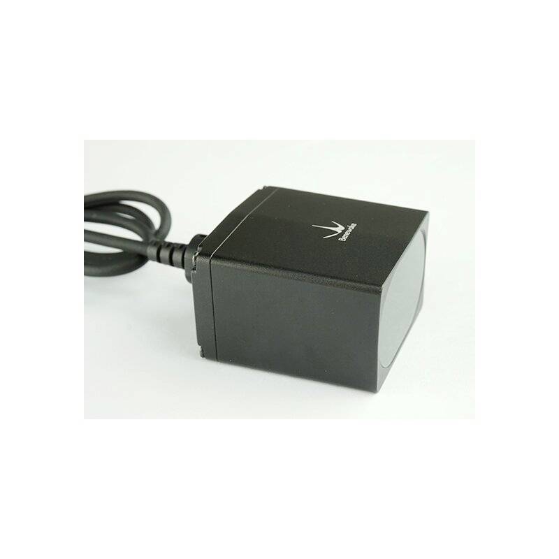 A black charger with a cable. It has a minimalist design and a small logo on the top surface.