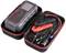 Portable car jump starter in an open bag with crocodile clips, cables, and accessories, used for starting vehicle batteries.