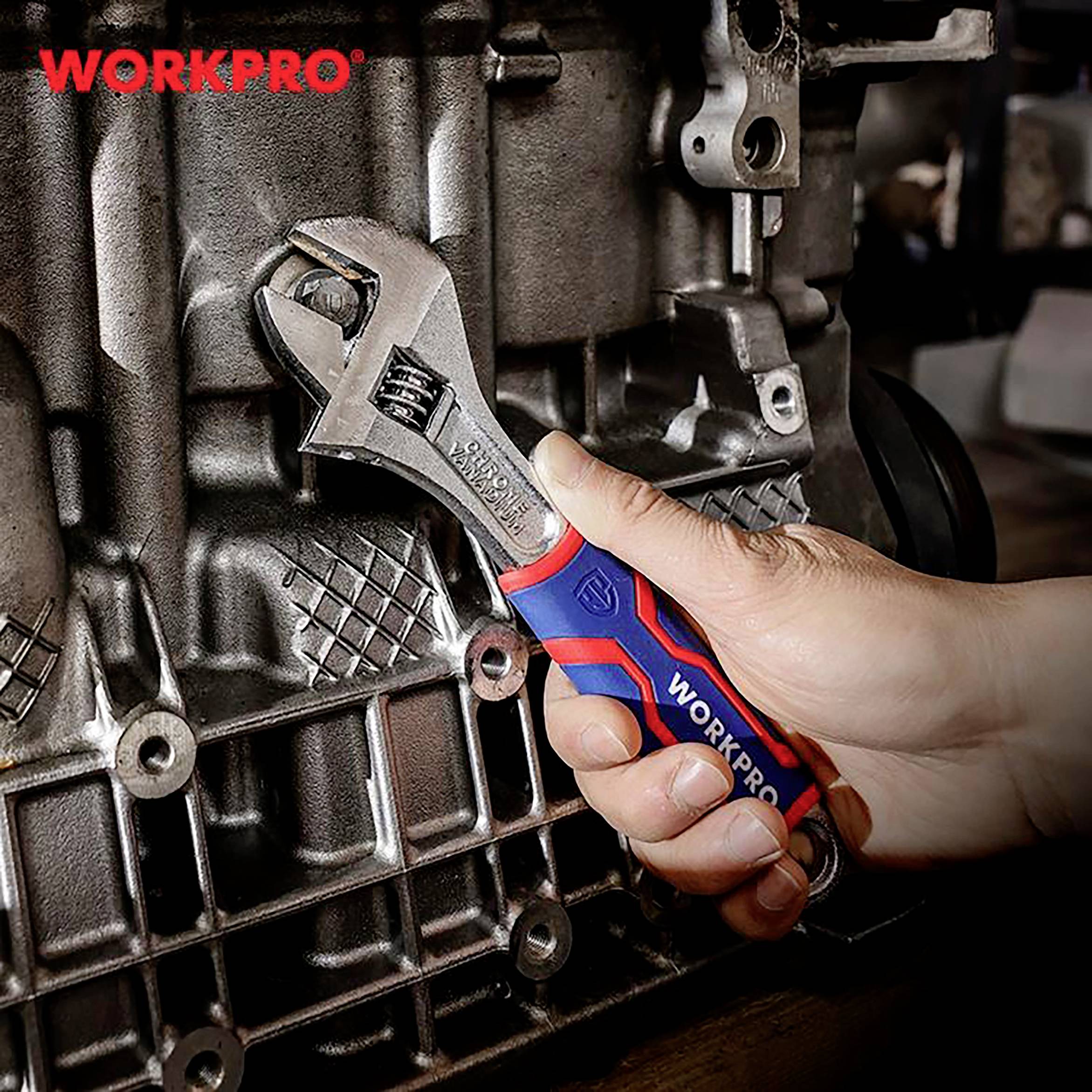 A hand holds an adjustable spanner and is working on a metallic machine part.