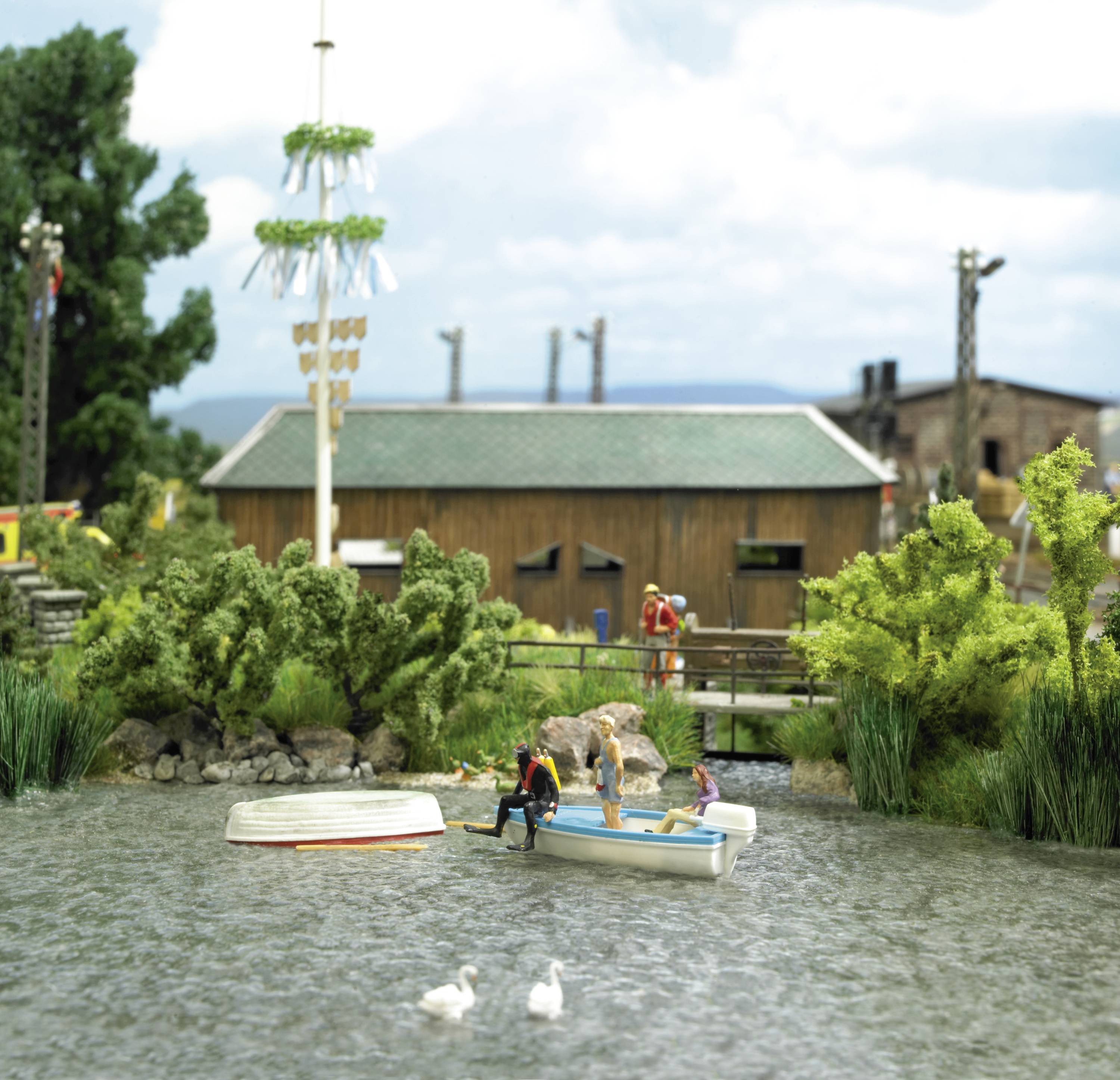 A lake with two ducks, an overturned boat and another boat with people. Trees and a building can be seen in the background.