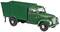 A green model of a historic delivery van with a rectangular cargo area and distinctive headlamps on a white background.
