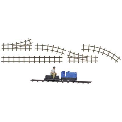 Model railway set with straight and curved tracks, a small locomotive, and a figure sitting on the locomotive.