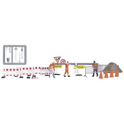 Construction workers are setting up traffic cones and signs to secure a construction site. A sign indicates a diversion due to roadworks.