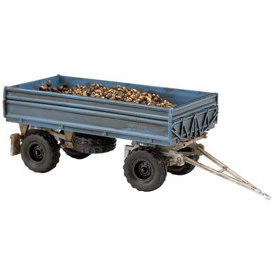 A blue trailer filled with chestnuts, resting on two axles, depicts a rural mode of transport.